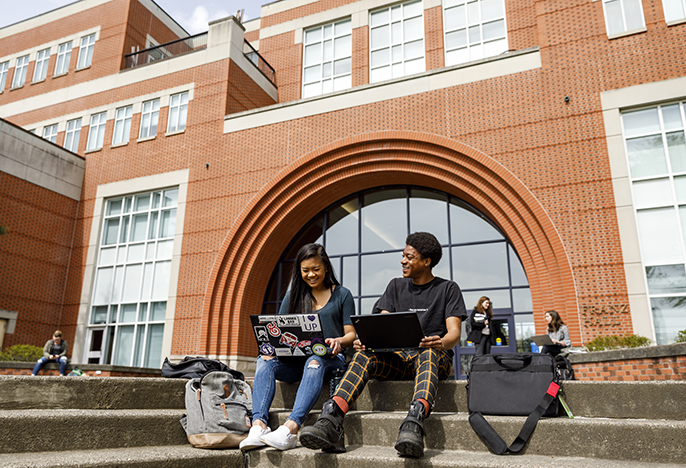 four students outside library