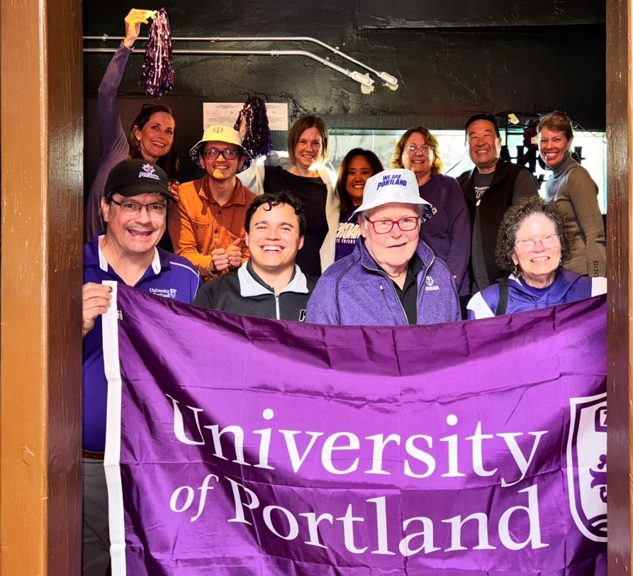 UP alumni holding UP Logo flag
