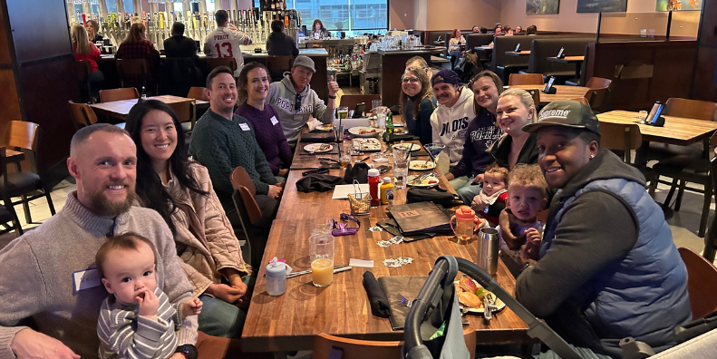 Alumni enjoying a meal after a traditional Christmas market outing