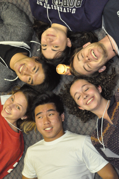 Students laying in a circle