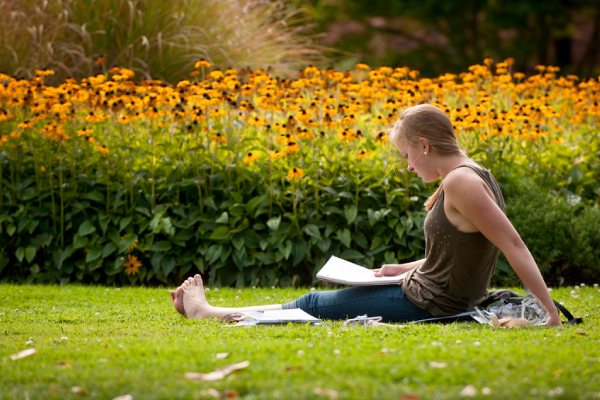 A woman reads in a garden
