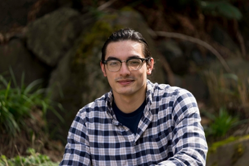 Photo of Austin De Dios sitting outside