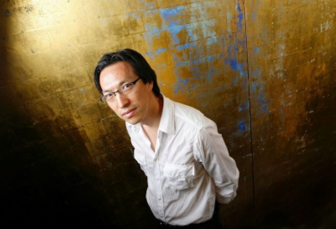 artist makoto fujimura standing in front of painting