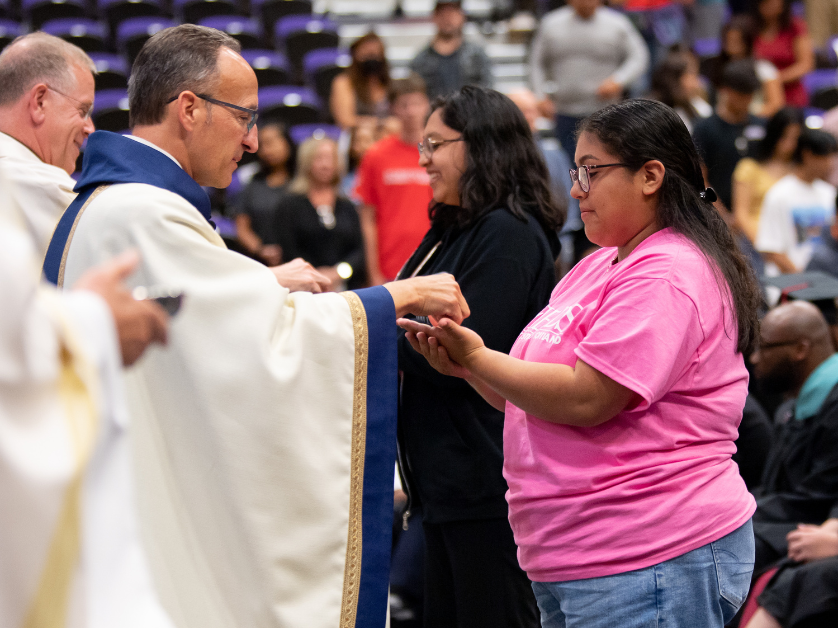 Priest distributing communion