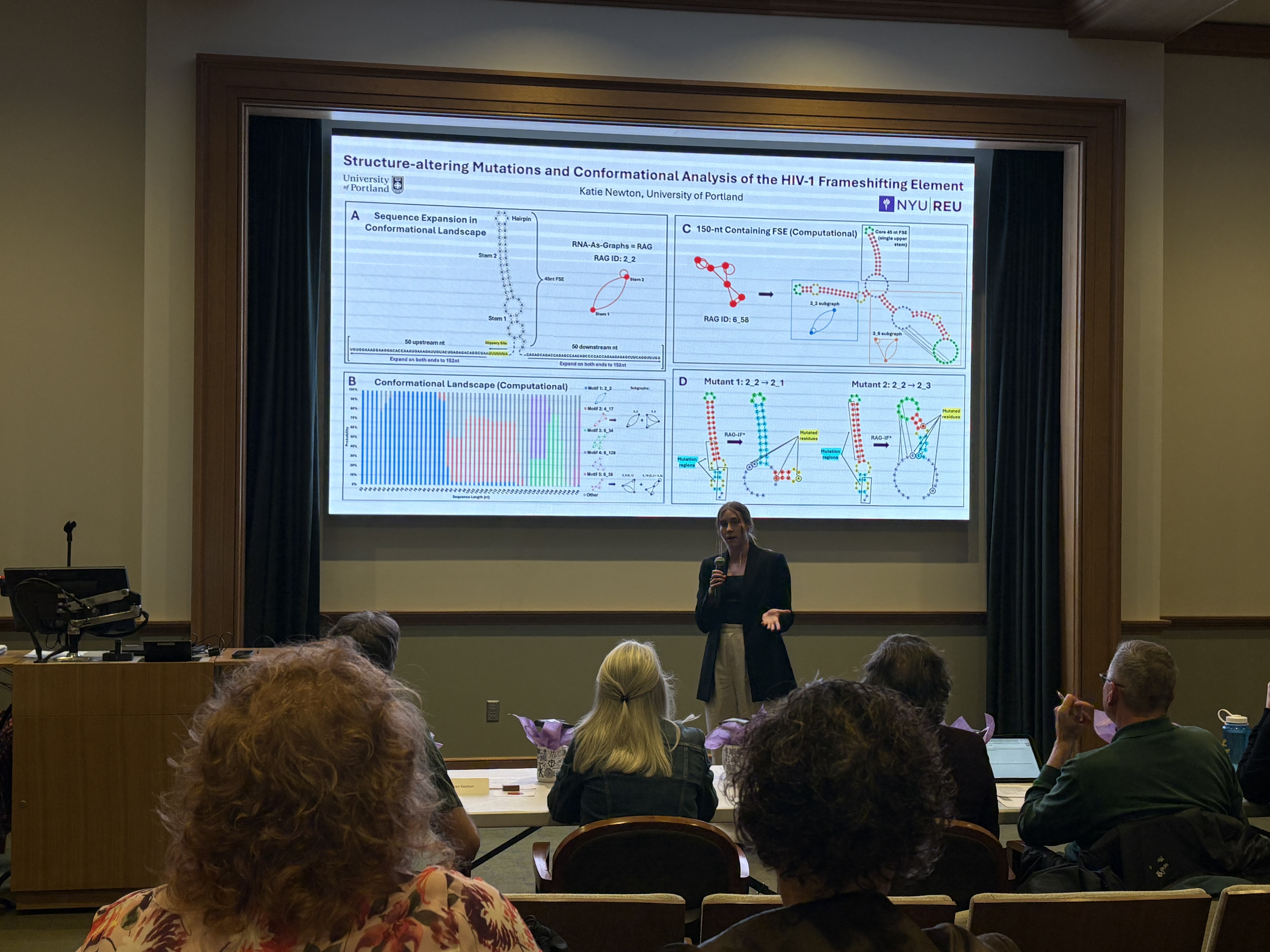 Katie Newton presenting her three minute thesis presentation to a panel of judges