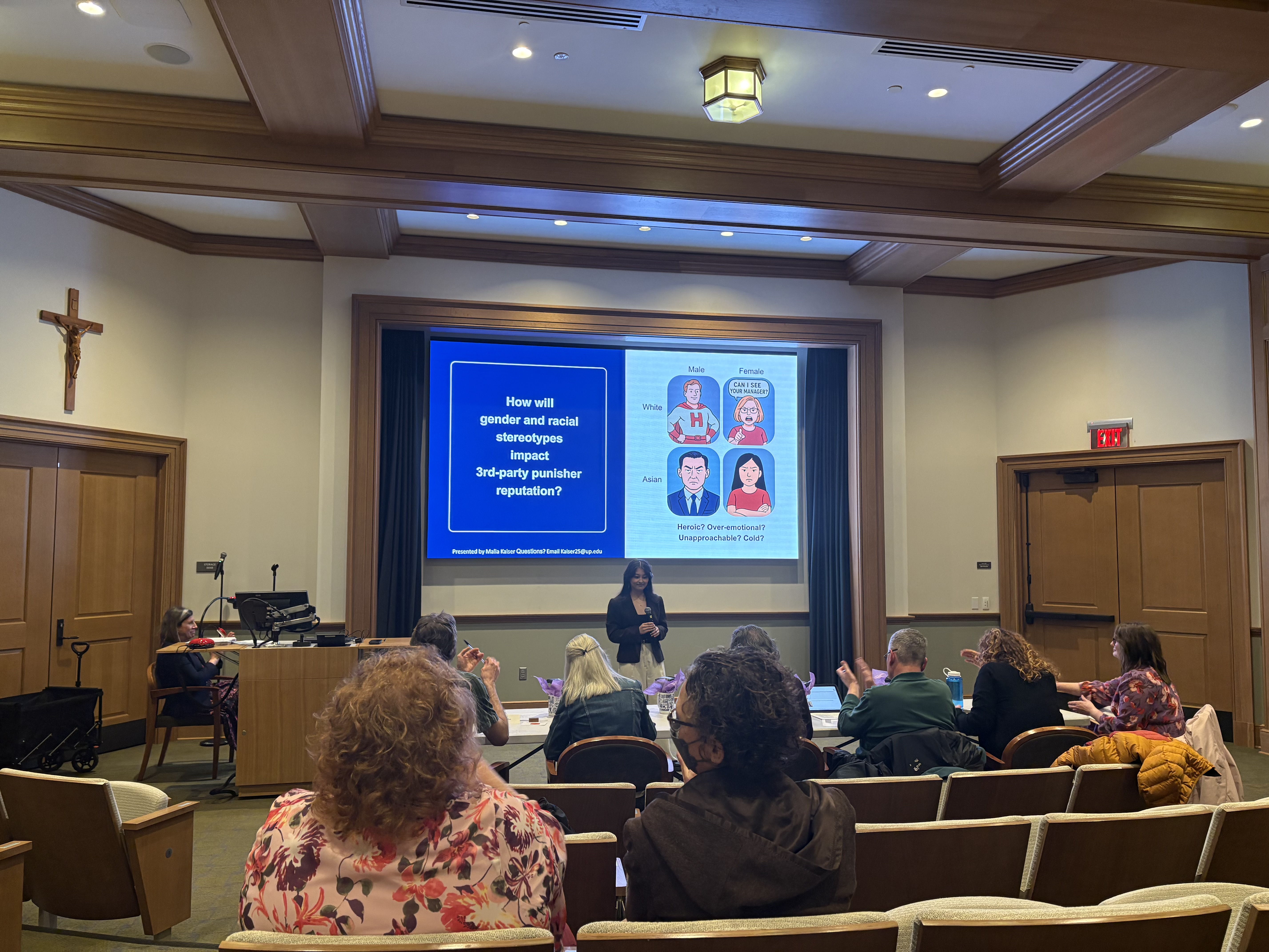 Malia Kaiser presenting her three minute thesis presentation to a panel of judges