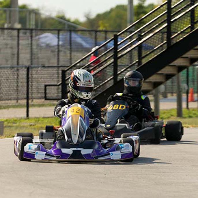 Cars driving around track.