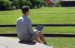 Student working on a laptop outside