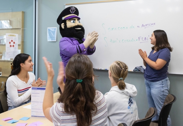 Wally and students at white board