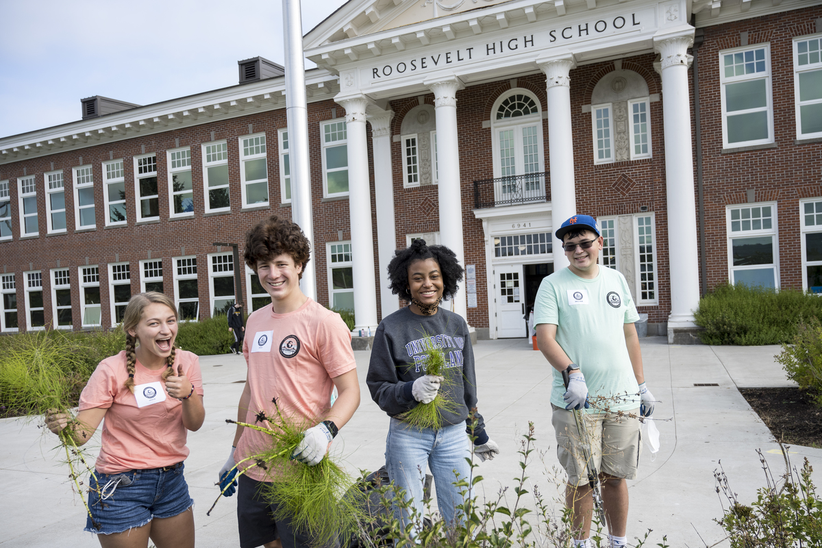 a group of students volunteering at Roosevelt High School during the Plunge.  Standing outside.