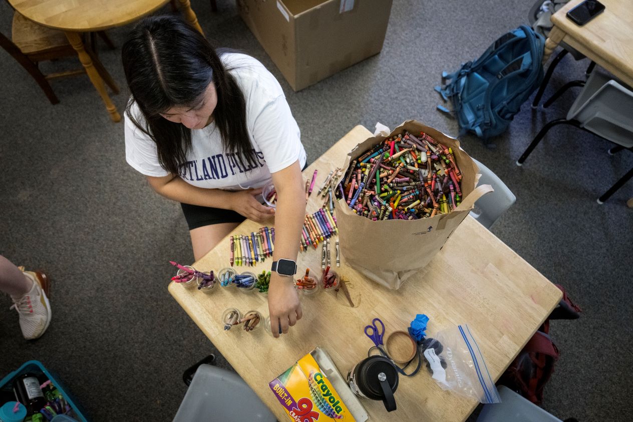 Students engage with children while volunteering with a community partner