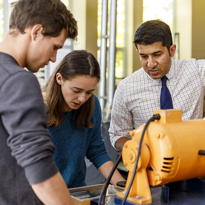 students working with professor