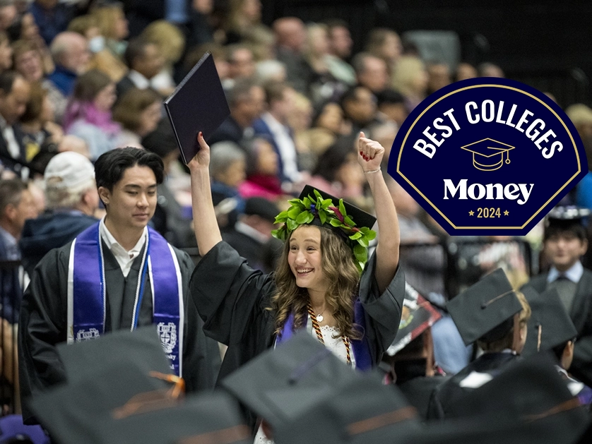 A happy graduate celebrates with her diploma at graduation