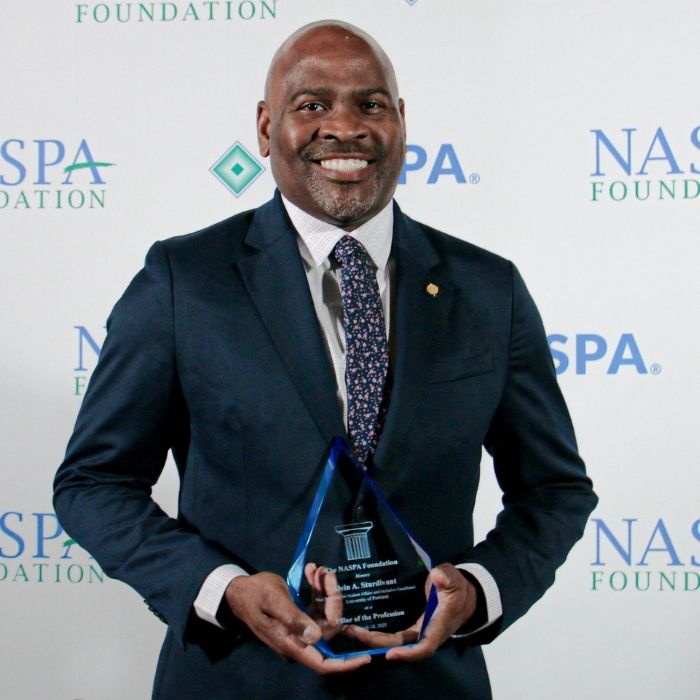 Alvin Sturdivant holding an award statue