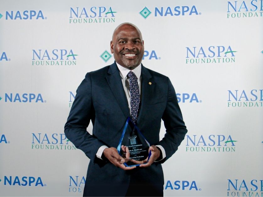 Alvin Sturdivant holding an award statue