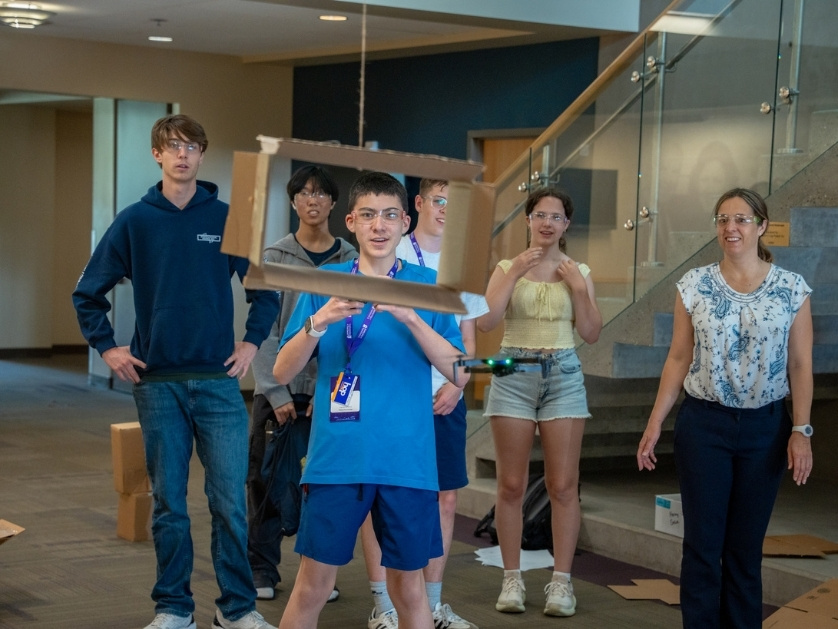 Precollege students navigate a drone through obstacles in the Shiley Marcos Center for Design and Innovation