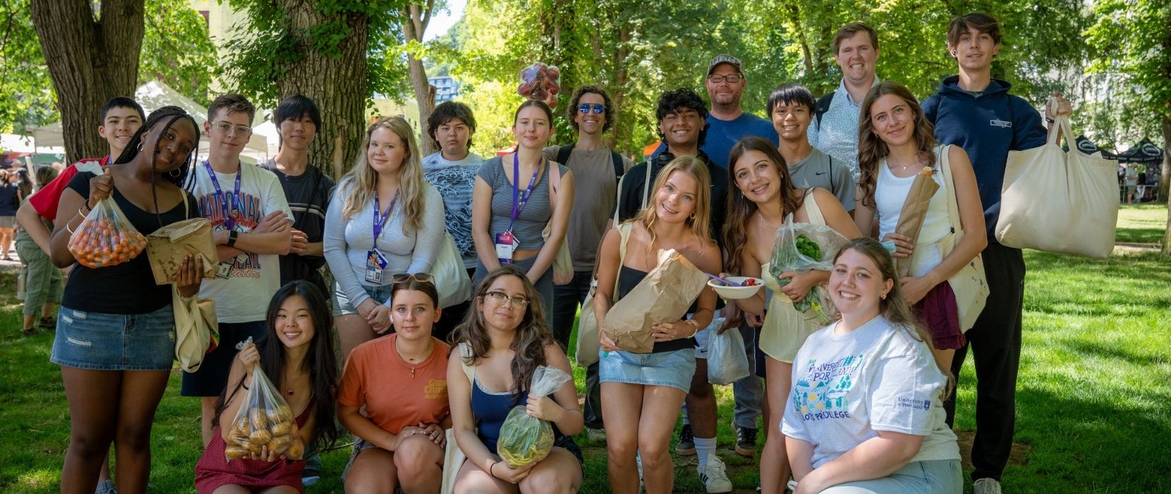 a group of people posing for a photo in a park