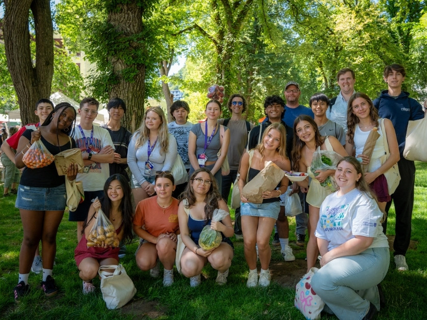 a group of people posing for a photo in a park