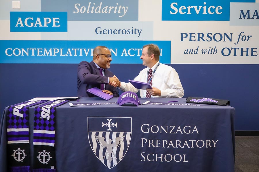 Dr. Kelly shakes hands with the President of Gonzaga preparatory school