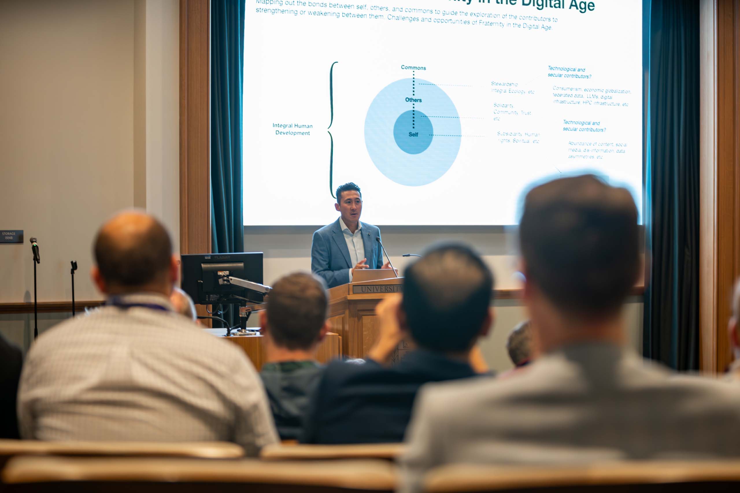 Speaker standing in front of slide before an audience at the Higher Education and Artificial Intelligence Conference in October of 2024