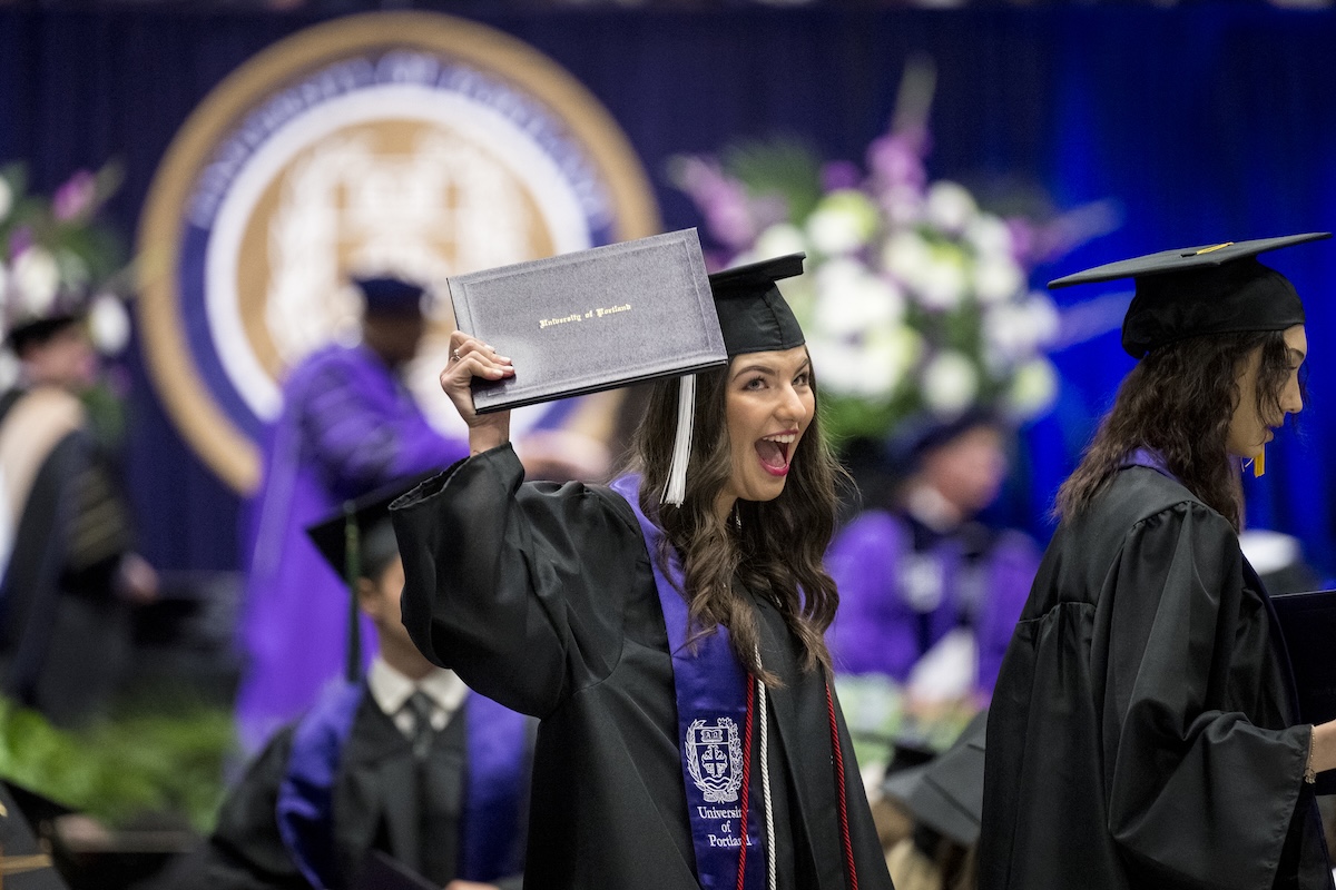 University of Portland graduate celebrating walking across stage