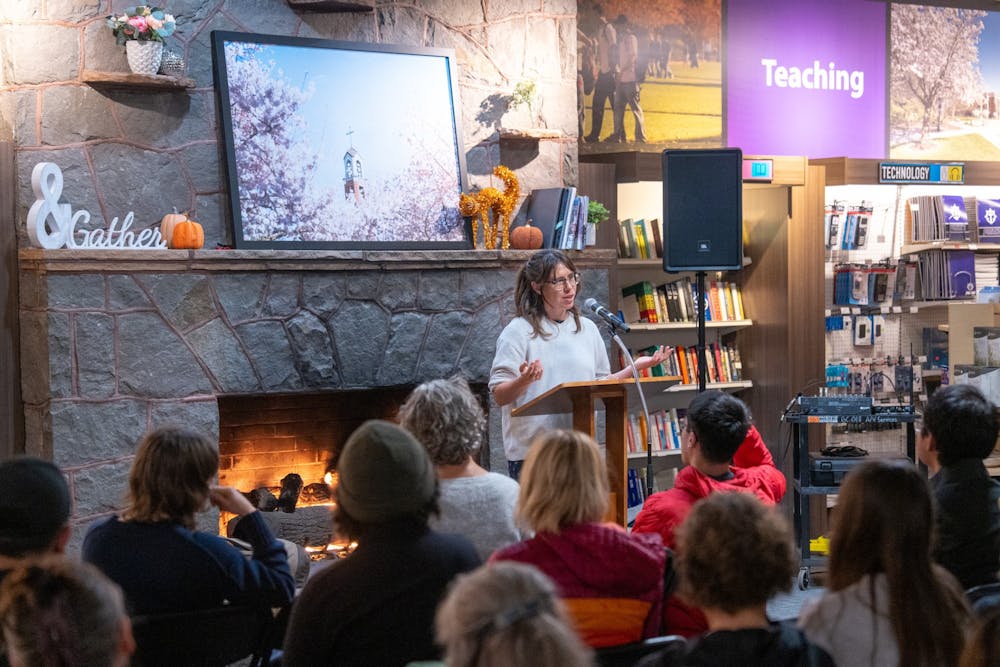 Lola Milholland reads from her book in front of a crowd at University of Portland bookstore