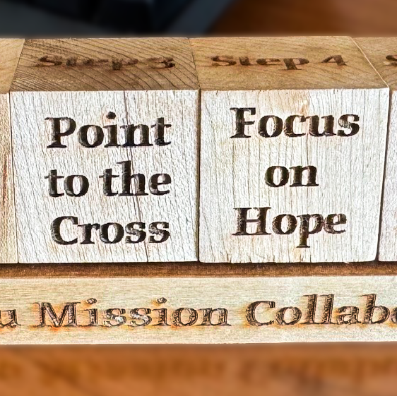 close up of two wooden blocks that say 'Point to the Cross' and 'Focus on Hope'
