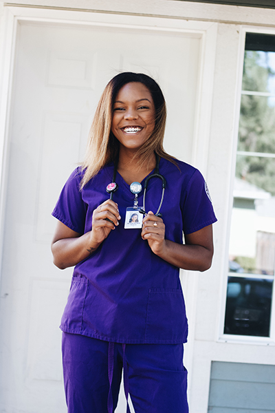 Kianni Demmert in purple scrubs