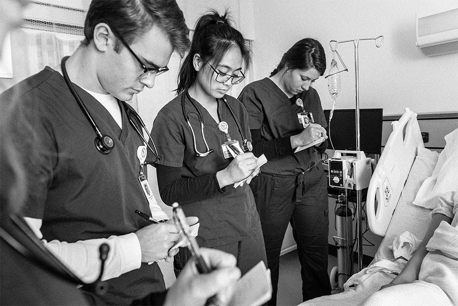 Three nursing students taking notes