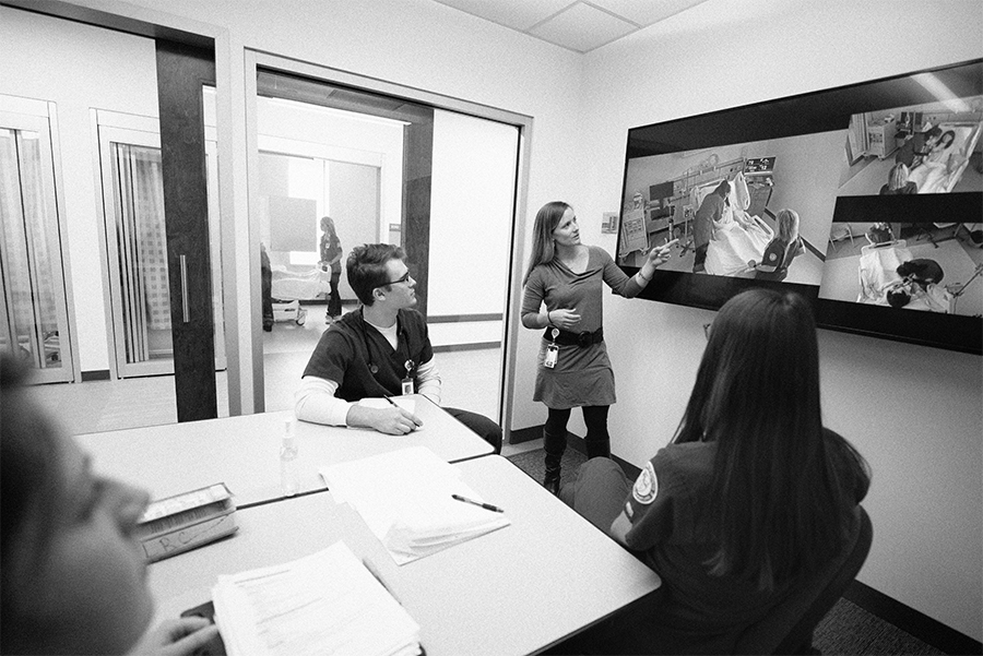 Nursing students and instructor in simulation debriefing room