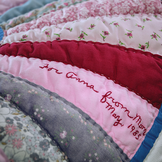 Quilt with handstitching reading For Anna from Mom
