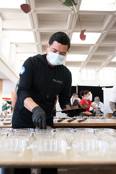 Man serving food wearing mask