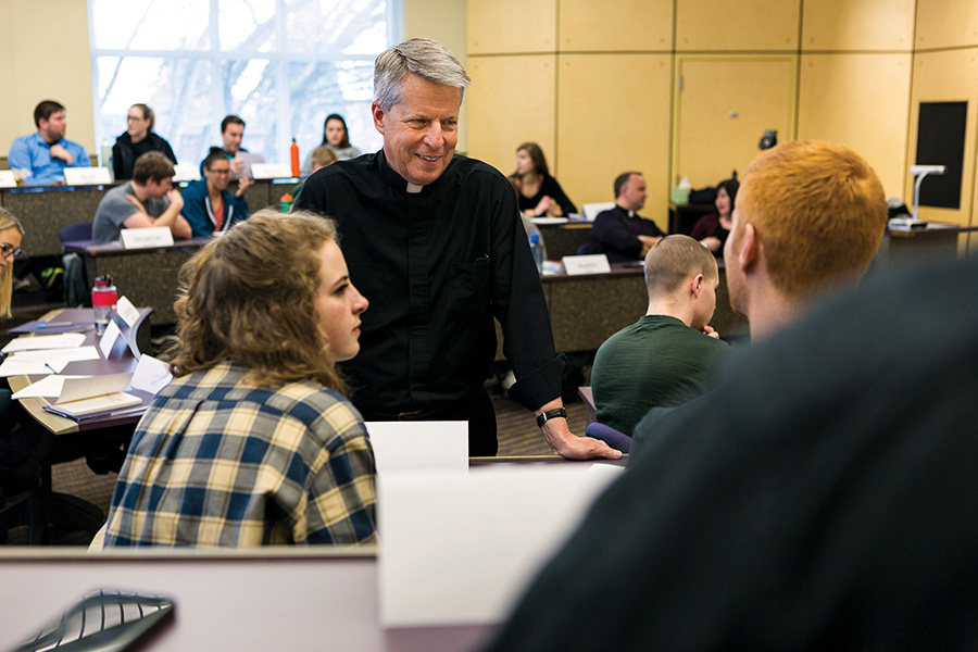 Father Mark Poorman teaching in a classroom