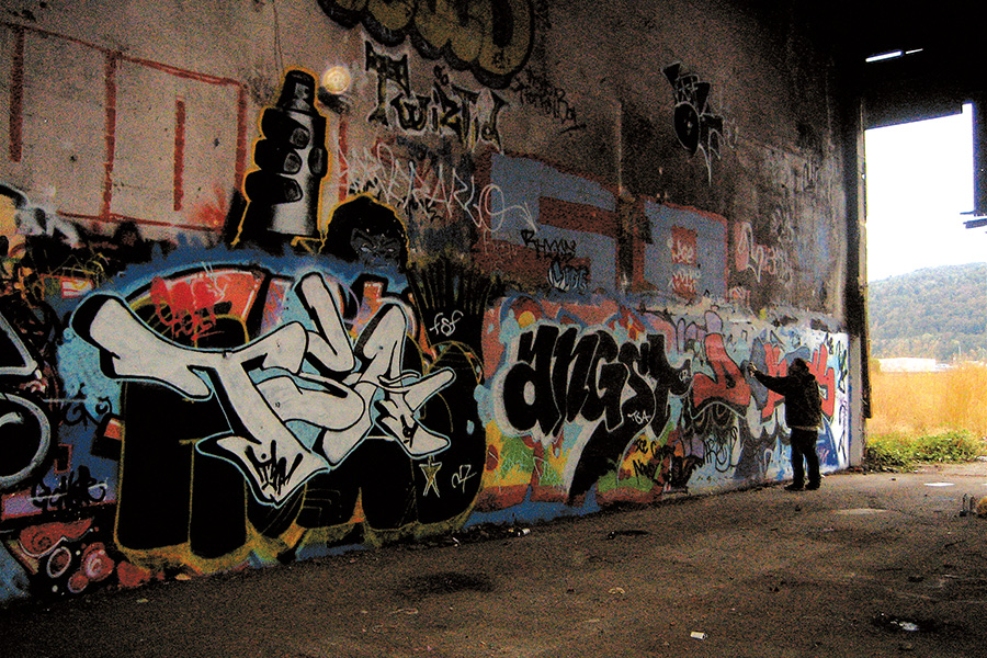 Man working on graffiti