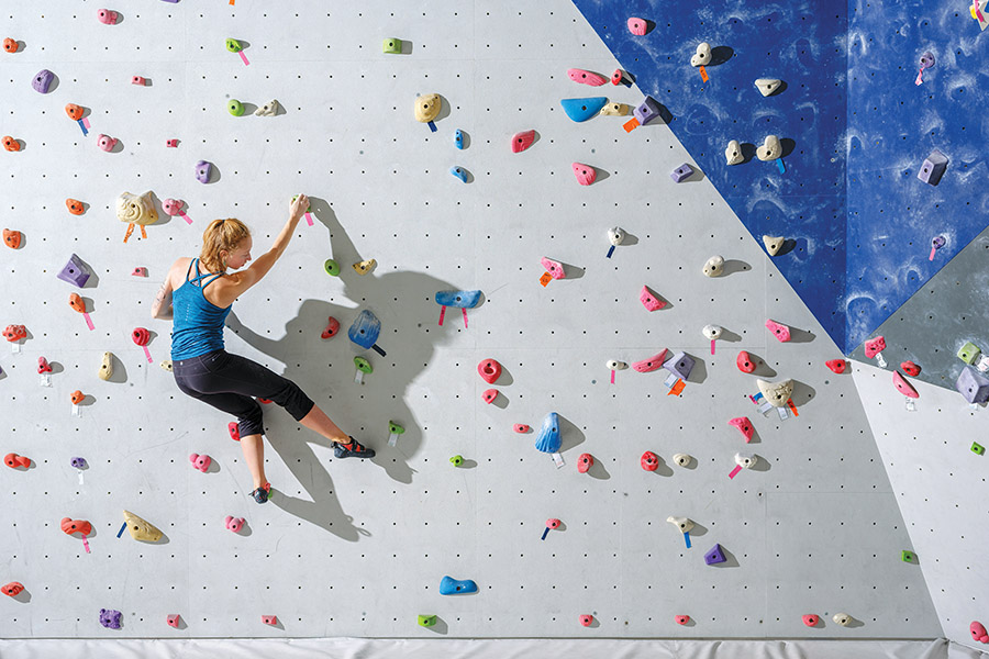 Cassidy Smith climbing a rock wall