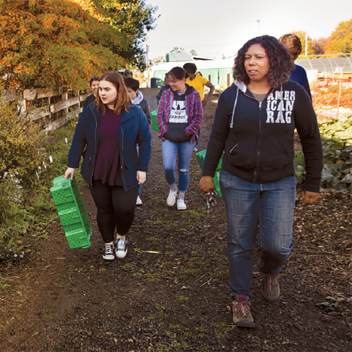 Students and staff walking through Mudbone Grown garden