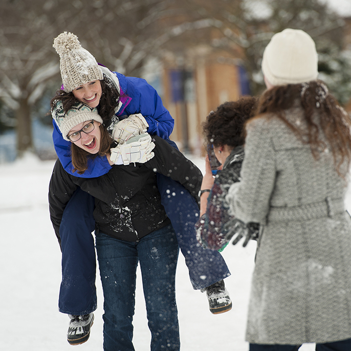 students taking photos in snow