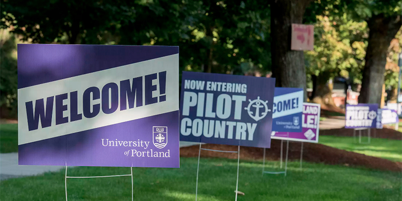 UP welcome signs on grass