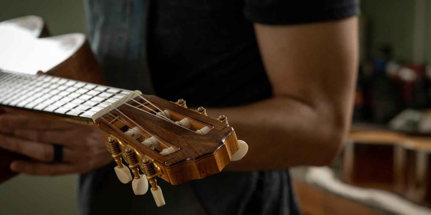 Max Sipe holds a guitar