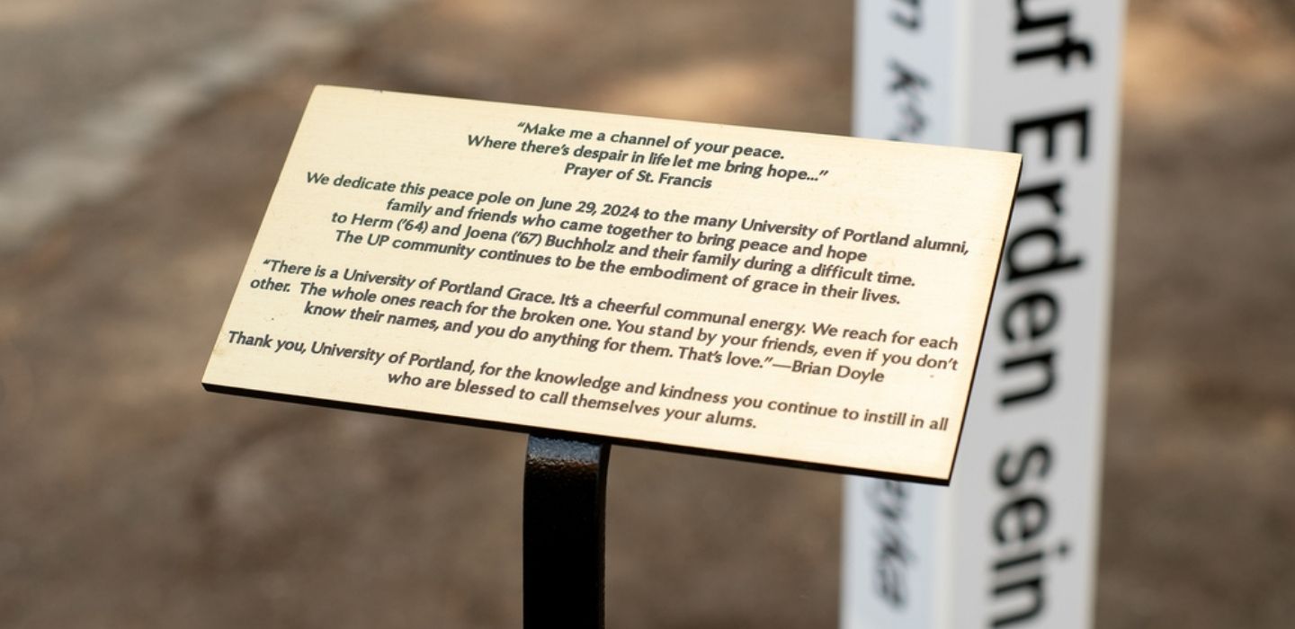 The brass dedication plaque for the peace pole