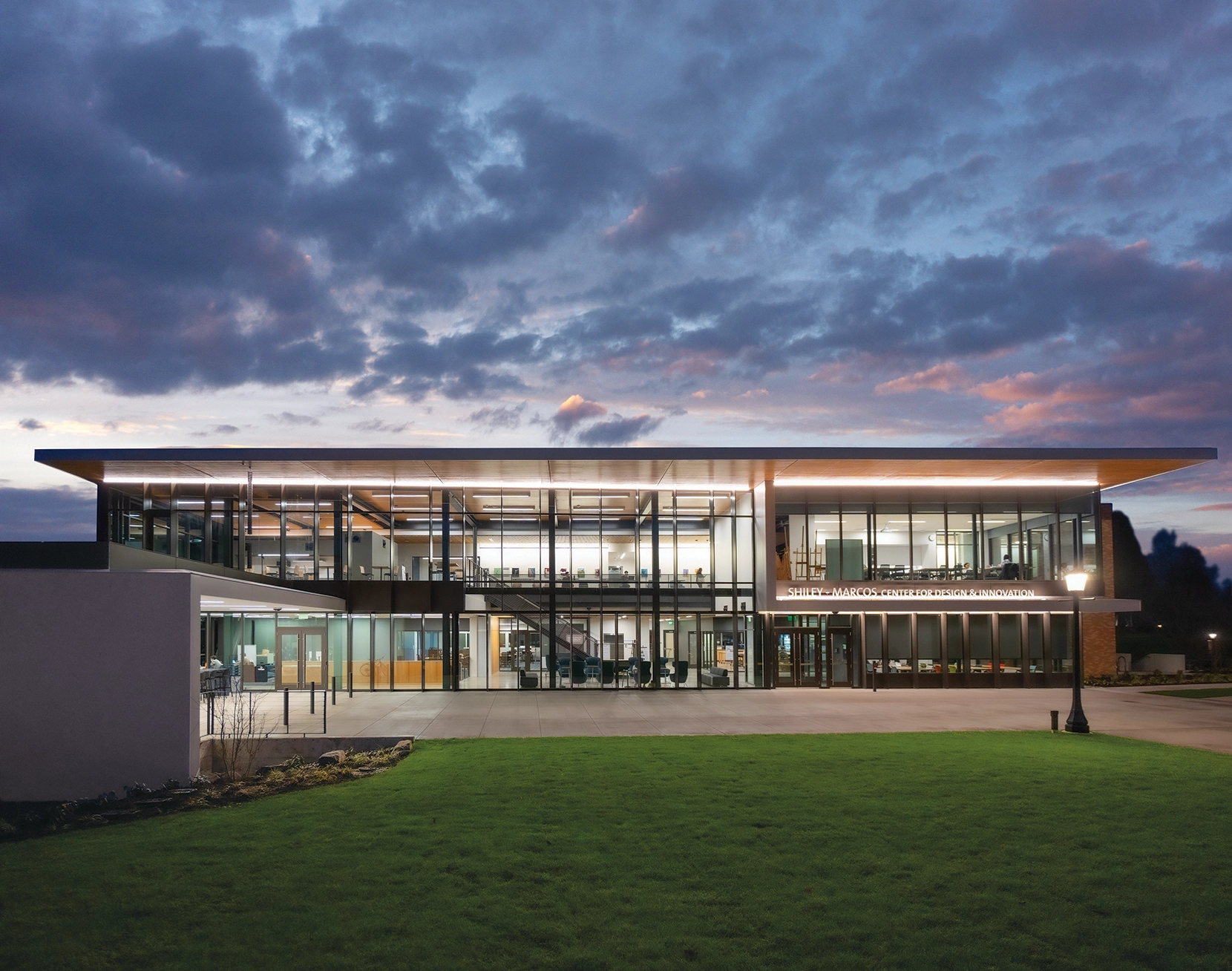 A photograph of the Shiley-Marcos center exterior facade at twilight