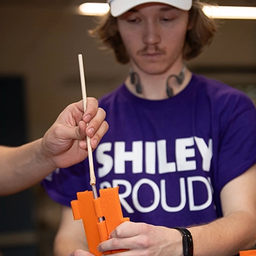 Two students manipulate a design in progress in the maker lab