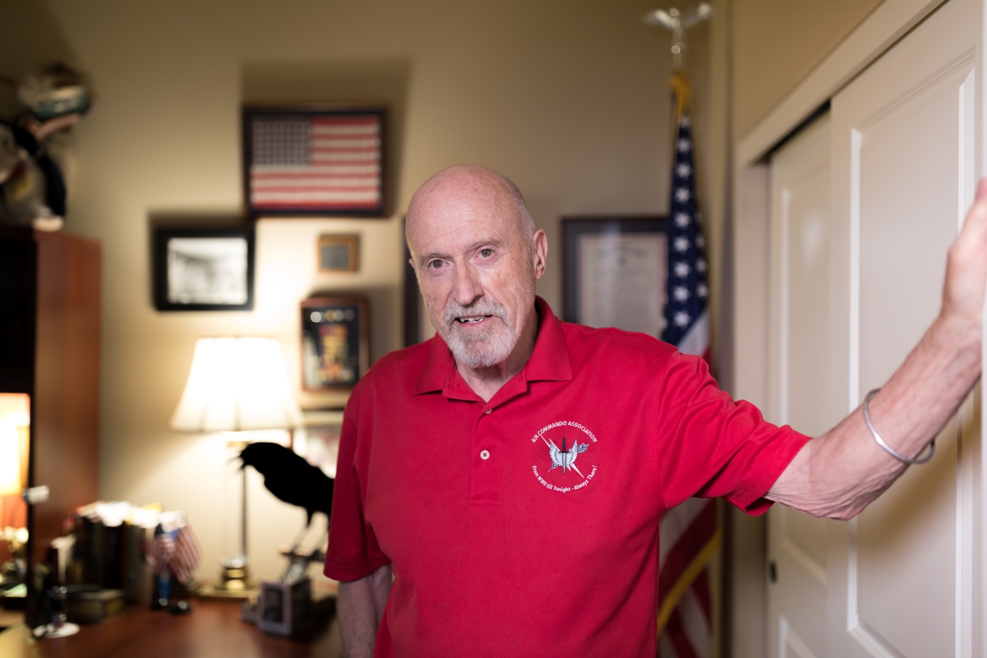 A portrait image Mike Burton standing in the doorway of his home.