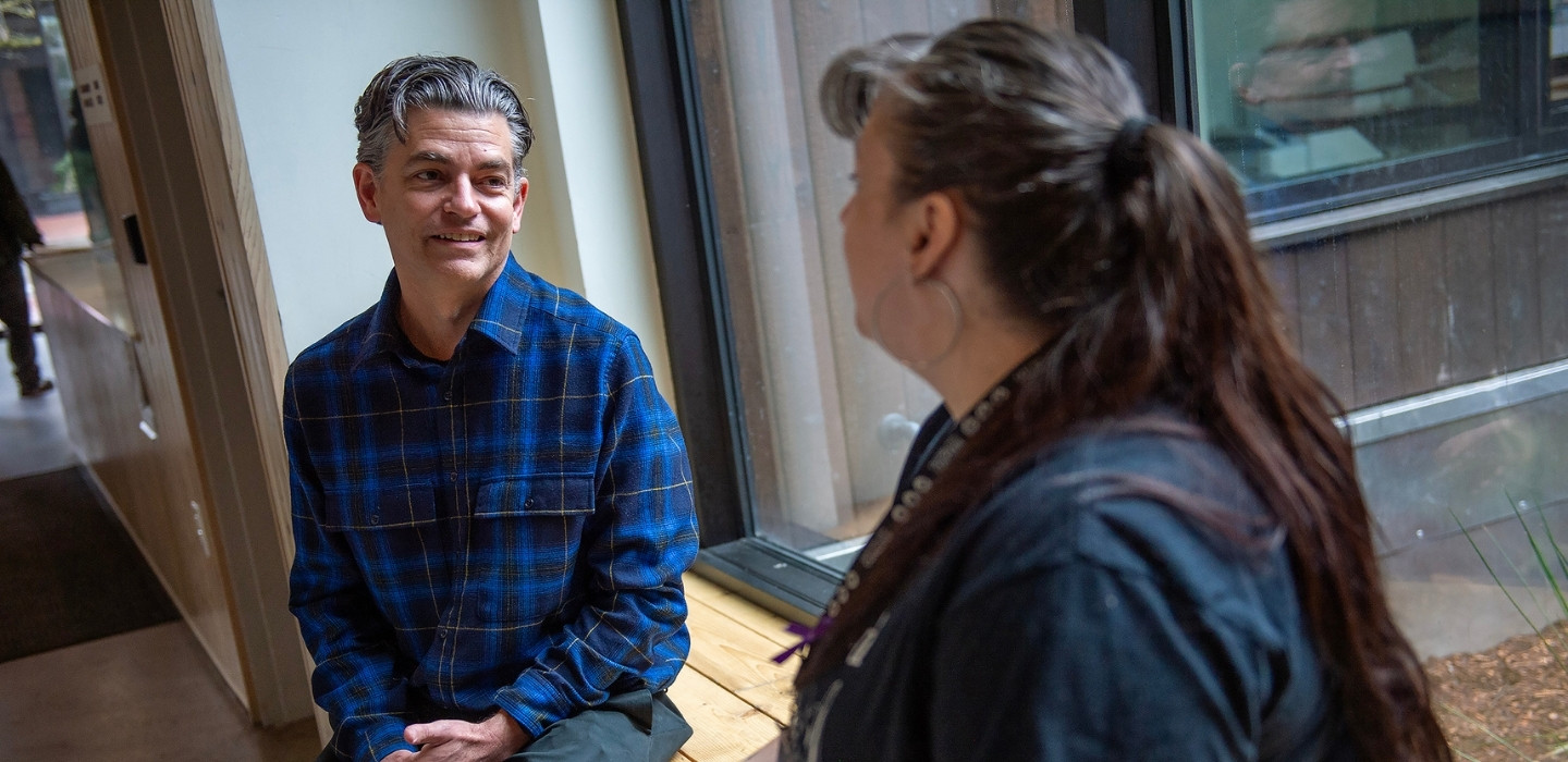 Andy speaking with a client at the office