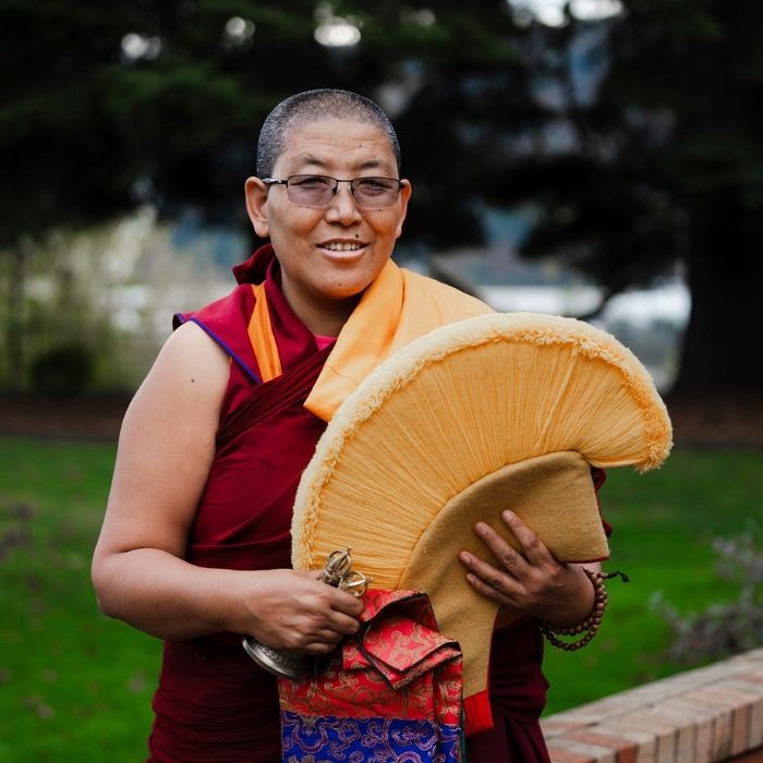 Geshema Yeshi Sangmo, holding the traditional yellow hat of the Gelug sect.