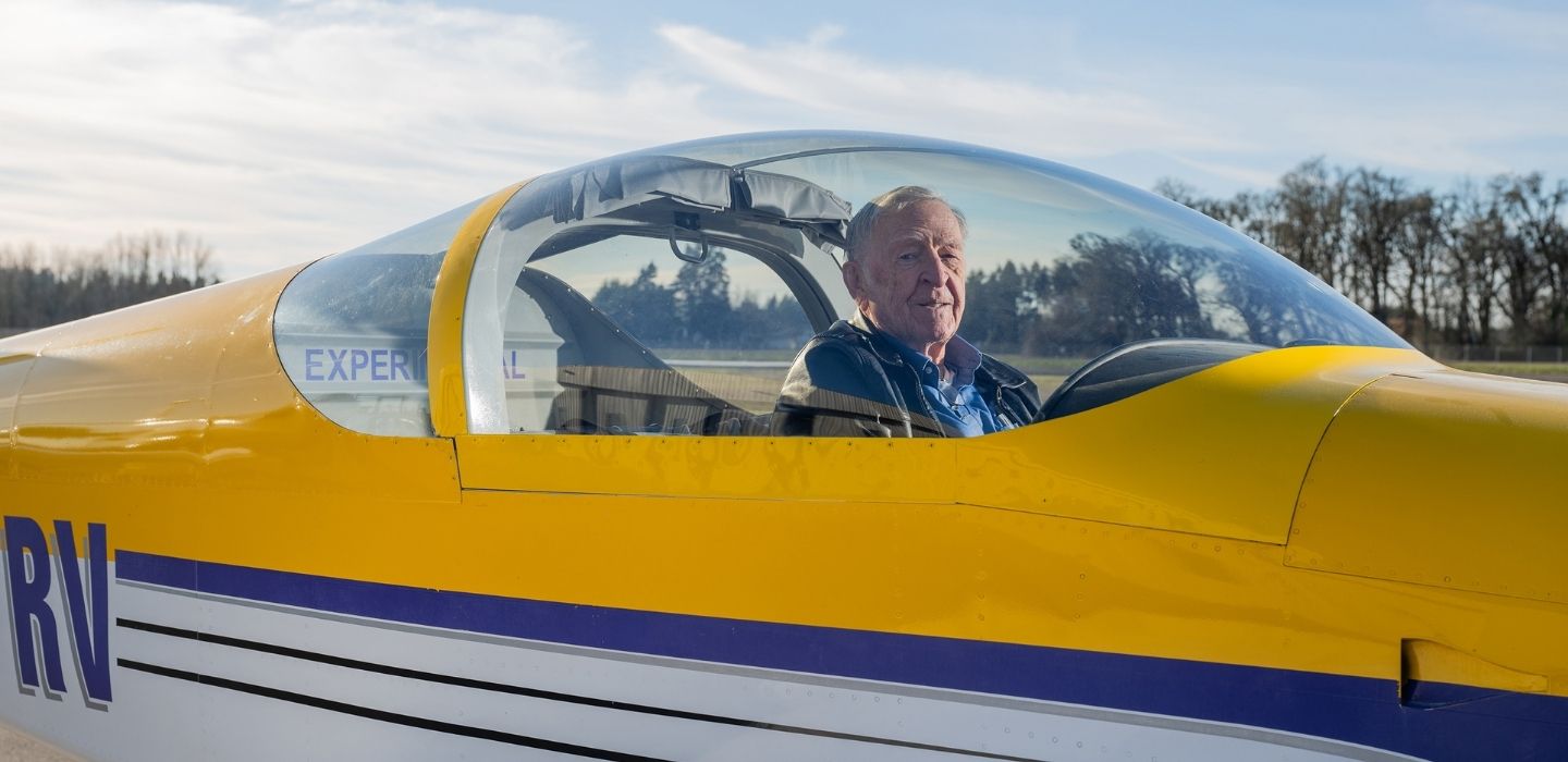A close up image of Richard VanGrunsven seated in the cockpit of one of his airplanes.