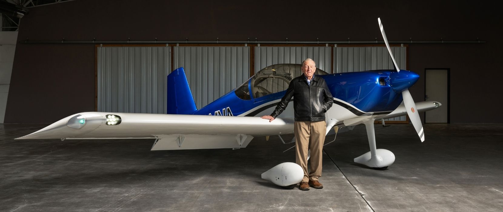 Richard VanGrunsven stands in the hangar in front of the aircraft he designed.
