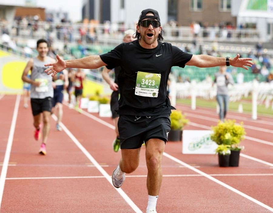 A runner crosses the finish line at a marathon