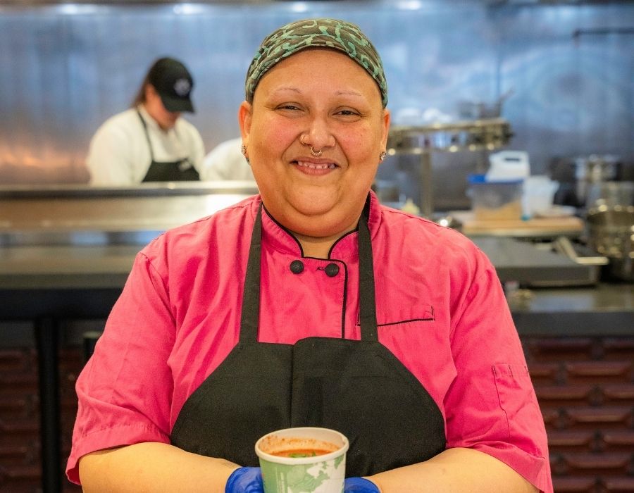 Monique Quintana, aka Mo, holds a cup of her homemade soup in the Bauccio Commons kitchen.