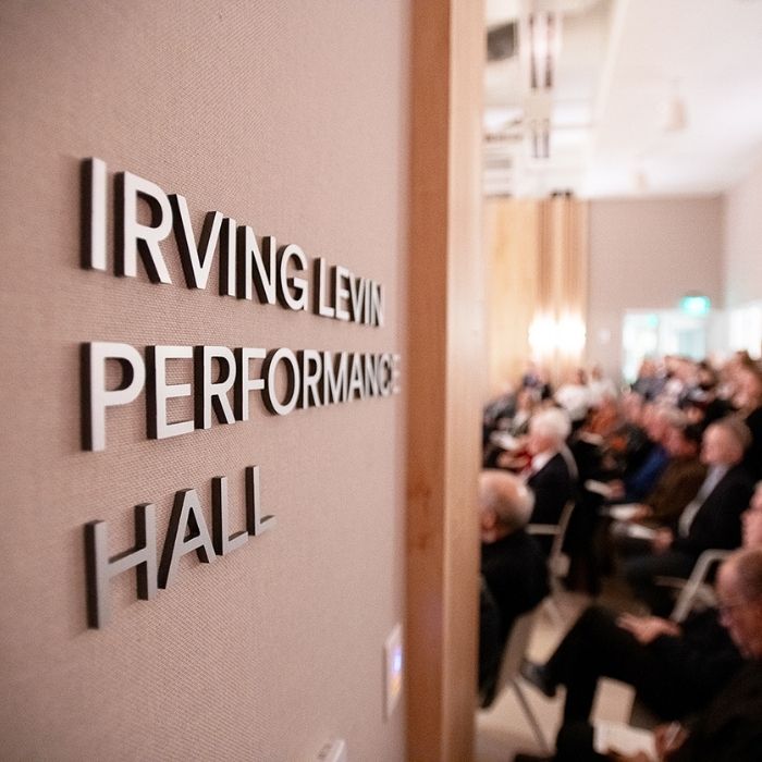 The entrance of a performance hall featuring a contemporary design with large windows and an inviting entrance.